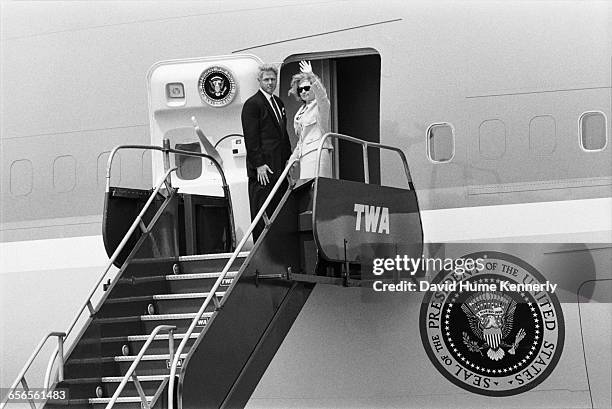 President Bill Clinton and First Lady Hillary Clinton board Air Force One on July 26, 1996 at JFK International Airport following a briefing and...