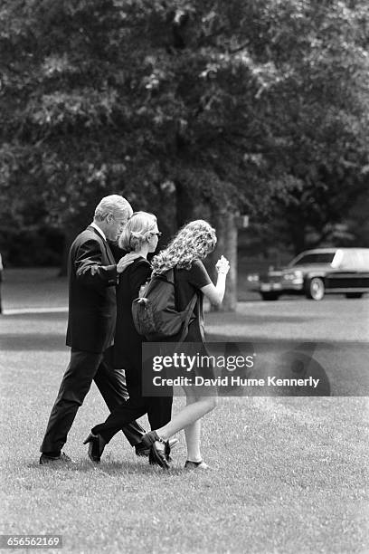 President Bill Clinton, First Lady Hillary Clinton, and daughter Chelsea Clinton walk on South Lawn to Marine One, about to depart for Camp David on...