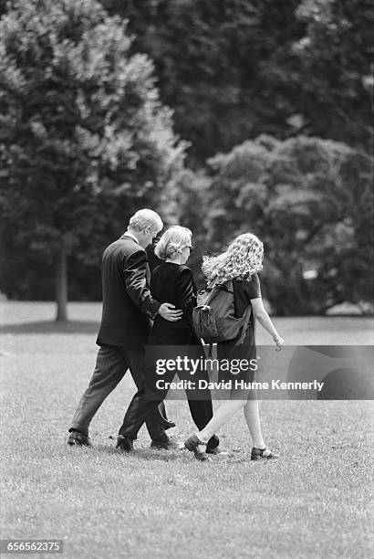 President Bill Clinton, First Lady Hillary Clinton, and daughter Chelsea Clinton walk on South Lawn to Marine One, about to depart for Camp David on...