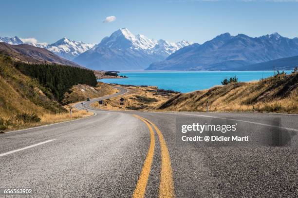 winding road leading to mt cook along lake pukaki in new zealand - new zealand road stock pictures, royalty-free photos & images