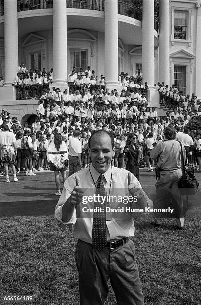 White House photographer Ralph Alswang stands in front of members of the U.S. Olympic Team on the South Lawn of the White House before a group...