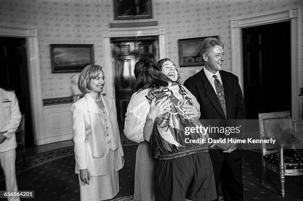 First Lady Hillary Clinton, daughter Chelsea and President Bill Clinton greet a member of the U.S. Olympic Team during a reception at the White House...