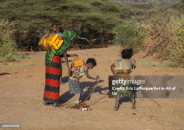 Borana tribe people carying jerricans filled with water, Oromia, Yabelo, Ethiopia on March 5, 2017 in Yabelo, Ethiopia.