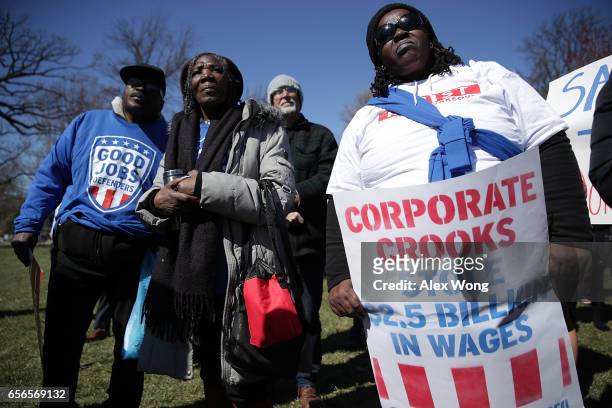 Activists hold signs as they participate in a rally in front of the Capitol March 22, 2017 in Washington, DC. U.S. Sens. Bernie Sanders and Elizabeth...