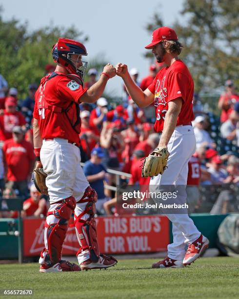 John Gant of the St. Louis Cardinals is congratulated by Eric Fryer after the final out against the Washington Nationals at a spring training game at...