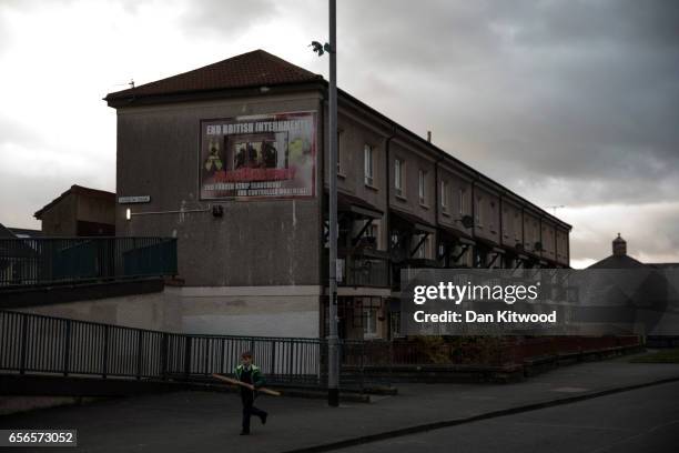 Boy runs past a republican sign close to the home of the late Martin McGuinness on March 22, 2017 in Londonderry, Northern Ireland. Northern...