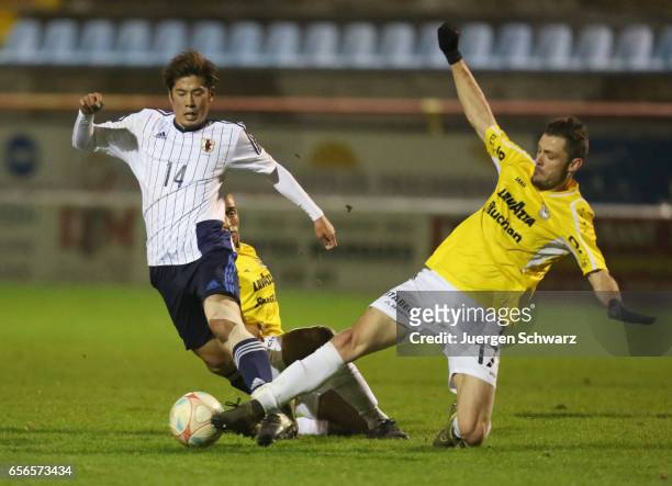 Akito Takagi of Japan tackles Julien Humbert of F91 during a friendly soccer match between F91 Diddeleng and the Japan U20 team at Stade Jos Nosbaum...