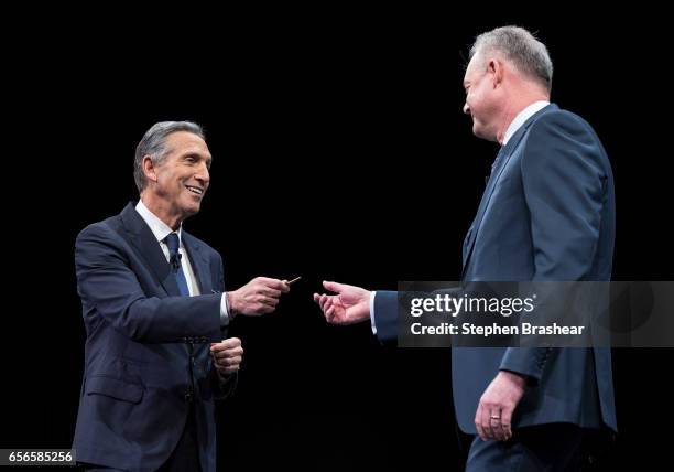 Howard Schultz hands over the key to the original Starbucks store to President and Chief Operating Officer Kevin Johnson during the Starbucks annual...