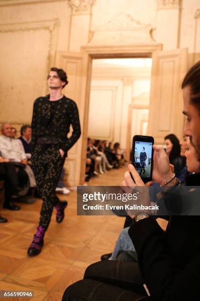 Spectator takes a cell phone photo of a model walking the runway at the Brand Who show during Mercedes-Benz Istanbul Fashion Week March 2017 at Grand...