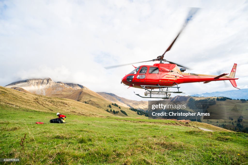 Mountain Rescue Helicopter Takes Off From Mountain Side