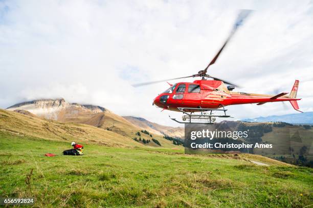 mountain rescue helicopter takes off from mountain side - search and rescue forest stock pictures, royalty-free photos & images