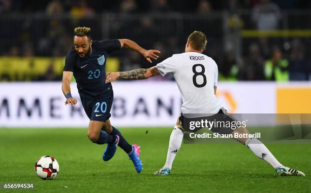 Toni Kroos of Germany attempts to stop Nathan Redmond of England during the international friendly match between Germany and England at Signal Iduna...