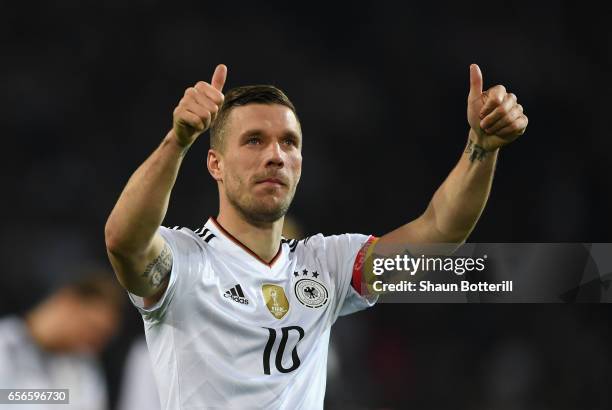 Lukas Podolski of Germany shows appreciation to the fans after his last international match for Germany after the international friendly match...