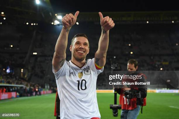 Lukas Podolski of Germany shows appreciation to the fans after his last international match for Germany after the international friendly match...