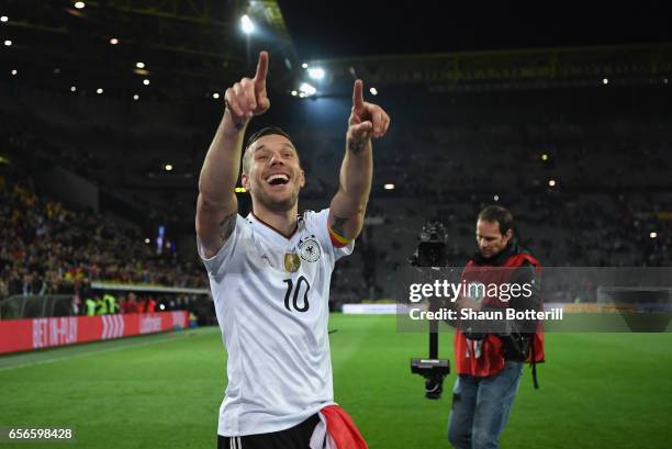 Lukas Podolski of Germany shows appreciation to the fans after his last international match for Germany after the international friendly match...