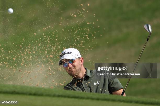 Bernd Wiesberger of Austria plays a shot out of the bunker on the 18th hole of his match during round one of the World Golf Championships-Dell...
