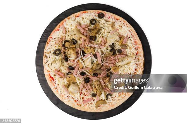 pizza ready to put in the oven on black plate and white background - harina bildbanksfoton och bilder