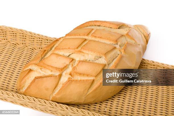 bread with cuts in a wicker basket and white background - horno pan stock pictures, royalty-free photos & images