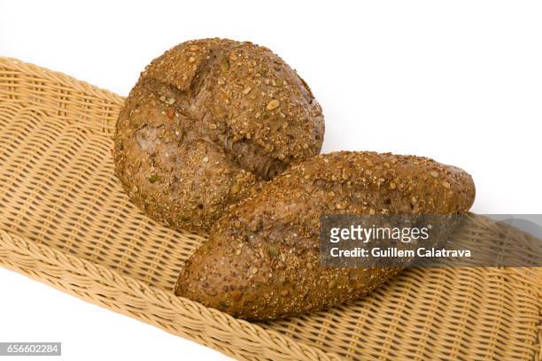 round and elongated round bread with seeds on wicker basket and white background - harina bildbanksfoton och bilder