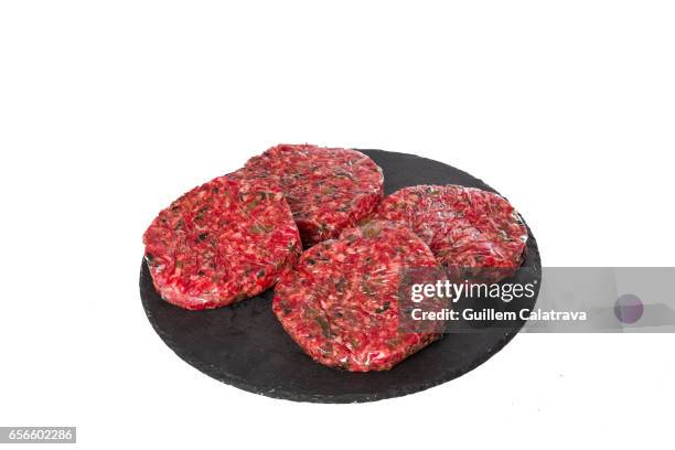 4 burgers with parsley on a black plate - tentempié stock pictures, royalty-free photos & images