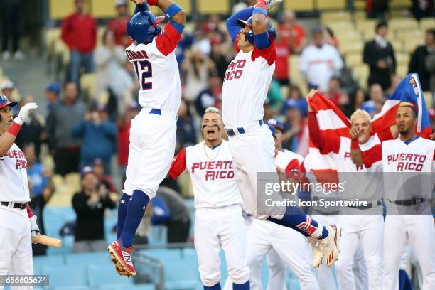 Puerto Rico's Carlos Correa celebrates with Francisco Lindor after hitting a home run in the first inning during the game against the Netherlands on...