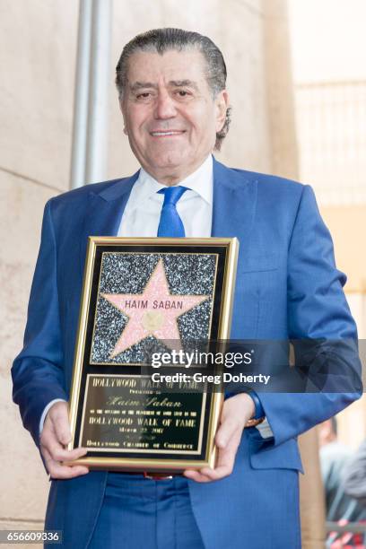 Haim Saban displays his award as he is honored with a star on The Hollywood Walk of Fame on March 22, 2017 in Hollywood, California.