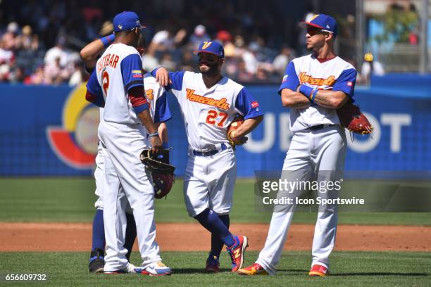 Venezuela Shortstop Alcides Escobar , Second baseman Jose Altuve and Infielder Hernan Perez look on during a pitching change during the World...