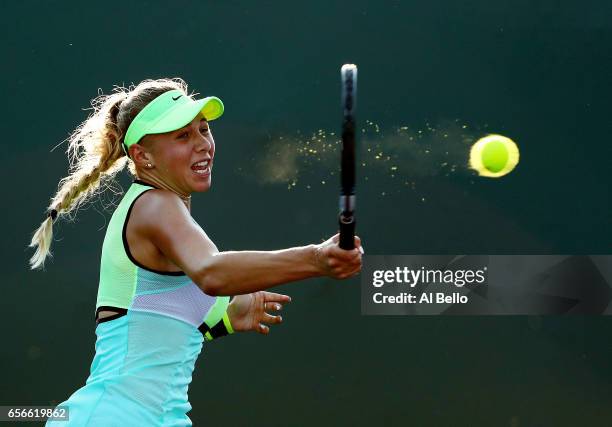 Amanda Anisimova returns a shot against Taylor Townsend during day 3 of the Miami Open at Crandon Park Tennis Center on March 22, 2017 in Key...