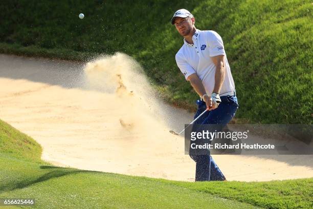 Chris Wood of England plays a shot out of a bunker on the 17th hole of his match during round one of the World Golf Championships-Dell Technologies...