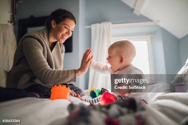 high five mum - baby play stock pictures, royalty-free photos & images