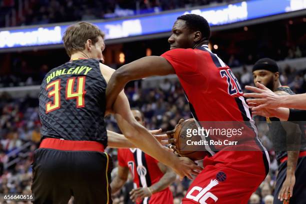Mike Dunleavy of the Atlanta Hawks and Ian Mahinmi of the Washington Wizards go up for a loose ball in the first half at Verizon Center on March 22,...