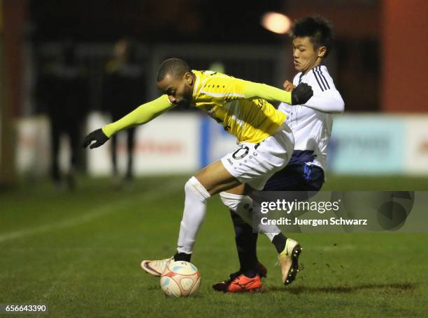 Reo Hatate of Japan tackles Alexandre Lauriente of F91 during a friendly soccer match between F91 Diddeleng and the Japan U20 team at Stade Jos...