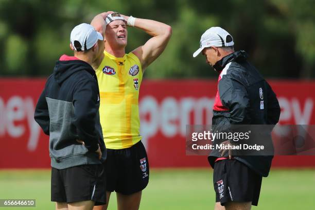 Saints head coach Alan Richardson inspects an injury sustained by Jack Newnes of the Saints during a St Kilda Saints AFL training session at Linen...