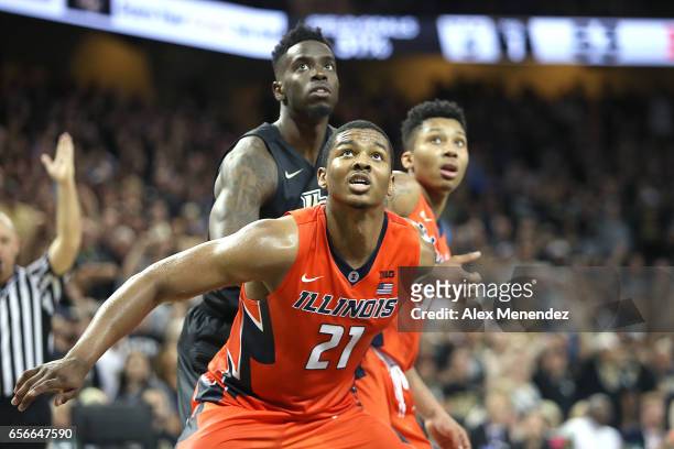 Malcolm Hill of the Illinois Fighting Illini blocks out Tanksley Efianayi of the UCF Knights during the 2017 NIT Championship quarterfinal game...