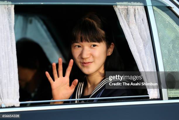 Princess Aiko waves to media reporters on arrival at the Imperial Palace to meet Emperor and Empress after graduating her junior high school on March...