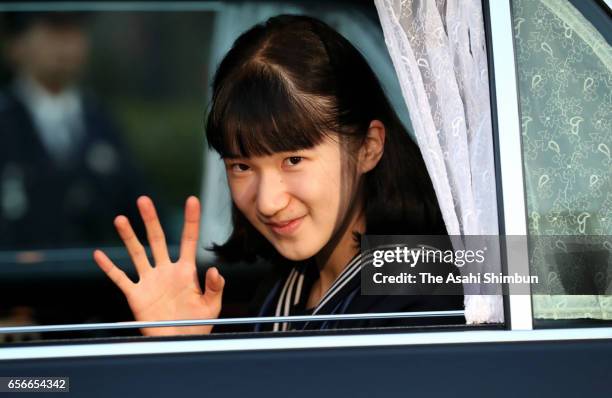 Princess Aiko waves to media reporters on arrival at the Imperial Palace to meet Emperor and Empress after graduating her junior high school on March...