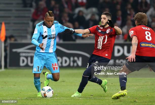 Clinton Njie of OM and Yassine Benzia of Lille in action during the French Ligue 1 match between Lille OSC and Olympique de Marseille at Stade...