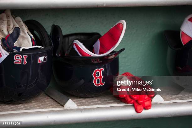 Dustin Pedroia of the Boston Red Sox batting helmet and batting gloves in the dugout during the Spring Training game against the Team USA at Jet Blu...