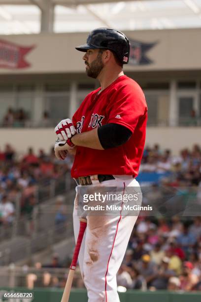 Mitch Moreland of the Boston Red Sox puts on his Franklin batting gloves during the spring Training game against the Team USA at Jet Blu Park on...