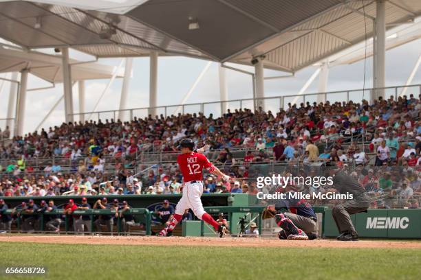 Brock Holt of the Boston Red Sox walks to the dugout in his Nike cleats during the spring Training game against the Team USA at Jet Blu Park on March...