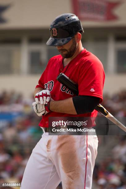 Mitch Moreland of the Boston Red Sox tightens his Franklin batting gloves during the spring Training game against the Team USA at Jet Blu Park on...