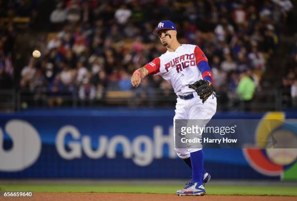 Javier Baez of team Puerto Rico throws out Brandon Crawford of team United States in the fourth inning during Game 3 of the Championship Round of the...