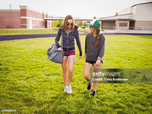 young women athletes leaving playing field - khaki shorts stock pictures, royalty-free photos & images
