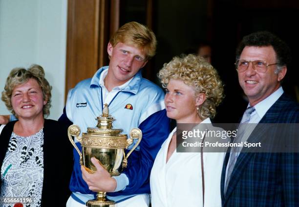 Boris Becker of West Germany with the trophy, surrounded by his family, after defeating Ivan Lendl of Czechoslovakia on Centre Court during the men's...