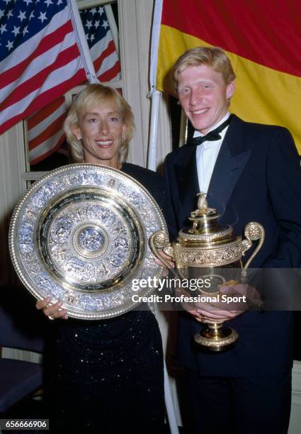 Ladies' singles champion Martina Navratilova of the USA and men's singles champion Boris Becker of West Germany hold their trophies during the...