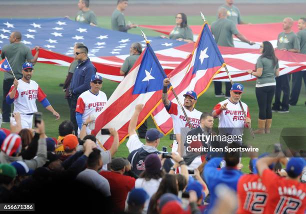 Team Puerto Rico catcher Yadier Molina and designated hitter Carlos Beltran lead there team onto the field while holding the flag of Puerto Rico...