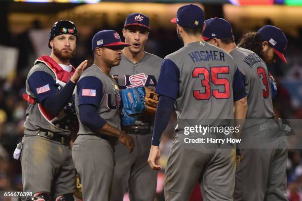 Starting pitcher Marcus Stroman of team United States is met by teammates on the mound after he gave up his no-hitter in the seventh inning against...