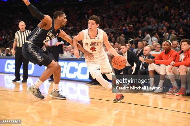 Federico Mussini of the St. John's Red Storm dribbles the ball around Rodney Pryor of the Georgetown Hoyas during the Big East Basketball Tournament...