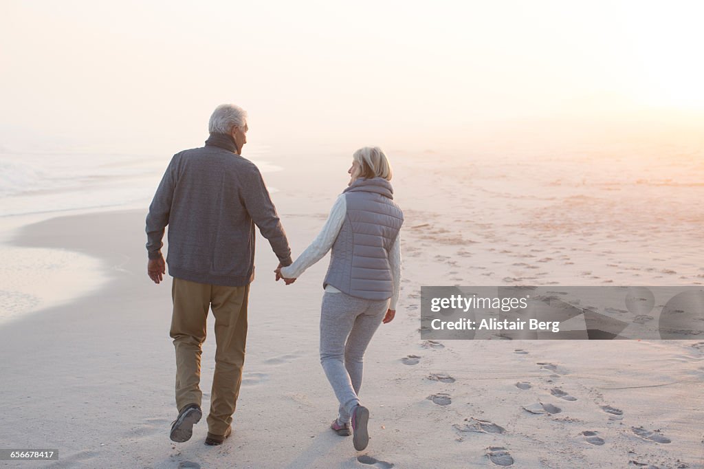 Senior couple walking on a beach together