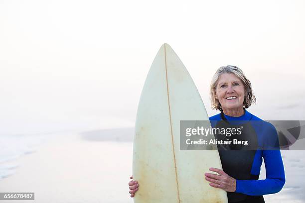 Senior woman with surf board